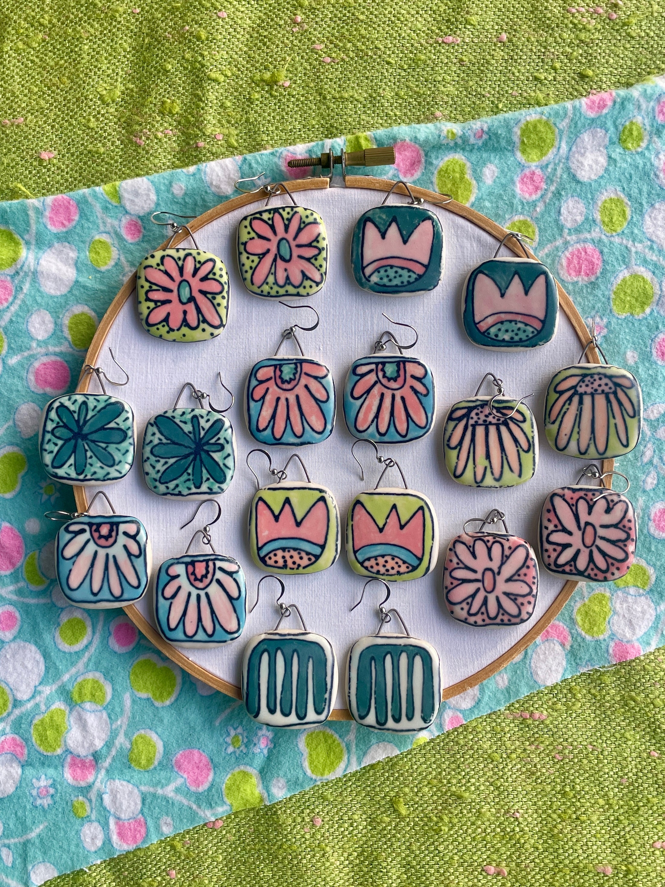 Eye-catching ceramic dangle earrings that make a statment.  Each pair is handcrafted and desined with vibrant colors and unique designs.  Lightweight and comfortable